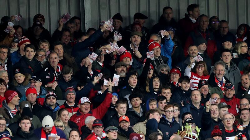 Gloucester supporters wave fake money at the Saracens players at Kingsholm. Photograph: David Rogers/Getty Images