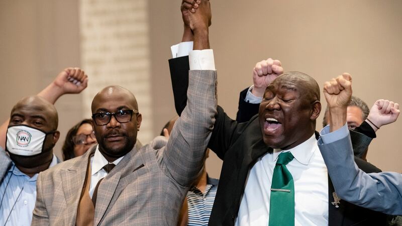 Philonise Floyd, brother of George Floyd (left), and attorney Ben Crump raise their hands in triumph during a news conference after the murder conviction against former Minneapolis police officer Derek Chauvin in the killing of George Floyd. Photograph: John Minchillo/AP