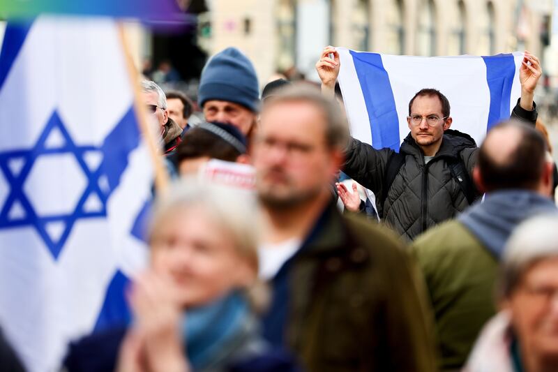 People with Israeli flags attend a rally of solidarity with Israel – 'against terror, hatred and anti-Semitism!' – in Munich in February