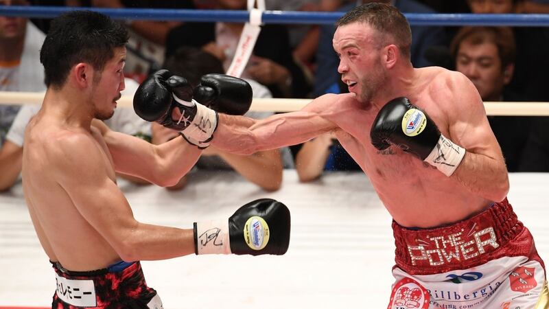 Ireland’s TJ Doheny in action  against Japoan’s  Ryosuke Iwasa  during their IBF super bantamweight title boxing bout in Tokyo. Photograph: Toshifumi Kitamura/AFP/Getty Images