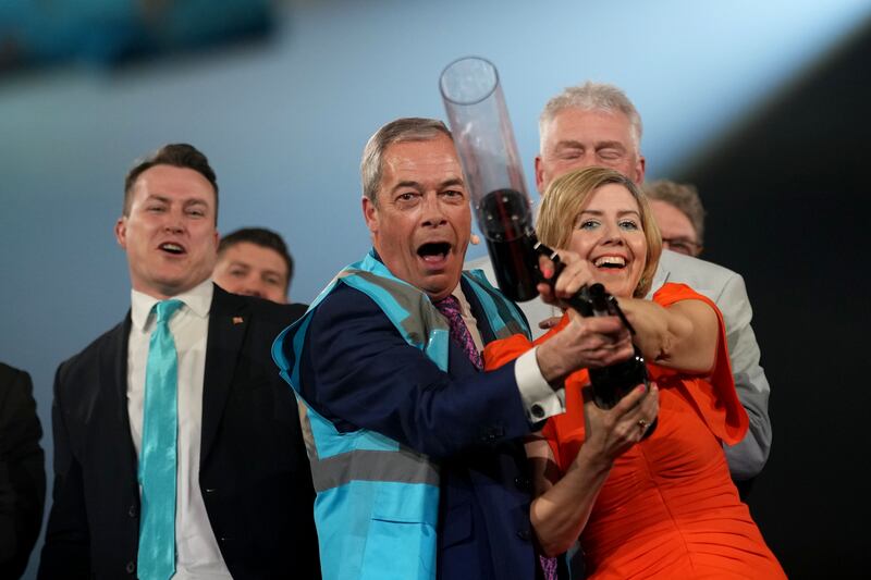 Reform UK leader Nigel Farage and the party's mayoral candidate Andrea Jenkyns fire high-visibility jackets into the crowd during the Reform UK campaign launch rally in Birmingham last Friday. Photograph: Christopher Furlong/Getty Images