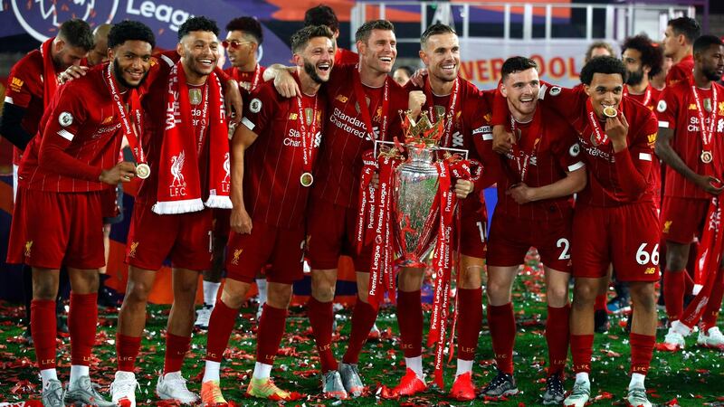 Joe Gomez, Alex Oxlade-Chamberlain, Adam Lallana, James Milner, Jordan Henderson, Andy Robertson and Trent Alexander-Arnold with the Premier League trophy. Photograph: Getty Images
