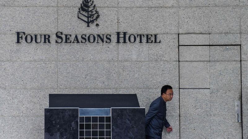 A member of staff outside the Four Seasons Hotel in Hong Kong from which Chinese billionaire Xiao Jianhua, founder of Beijing-based Tomorrow Group, was allegedly taken from his apartment by Chinese police. Photograph: Anthony Wallace/AFP/Getty Images.