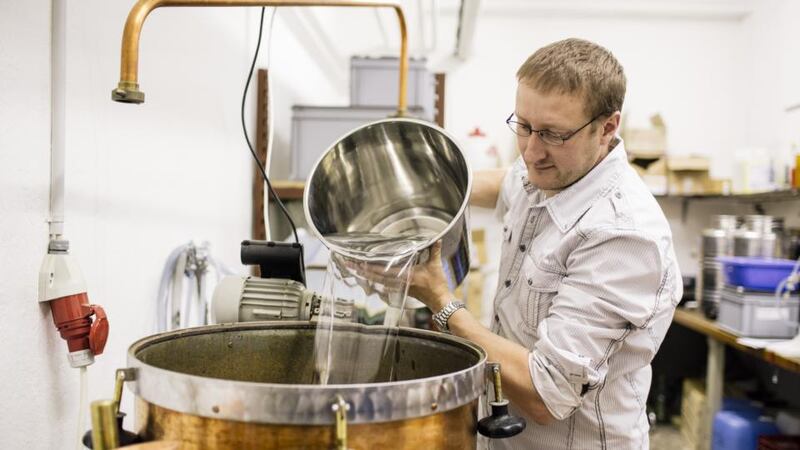 Christophe Racine prepares a batch of absinthe at his distillery in Motiers, Switzerland. Photograph: Niels Ackermann/The New York Times