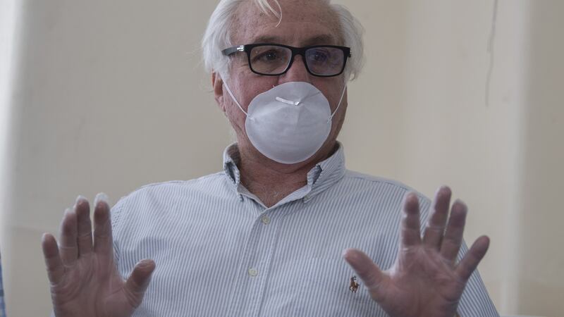 Dr Roberto Canessa, one of the 16 survivors of an air plane crash in the Chilean Andes in 1972, speaks with a group of robotics engineers and doctors while they prepare a ventilator being developed as part of the fight against Covid-19 in Montevideo last week. Photograph: Pablo Porciuncula/AFP via Getty Images