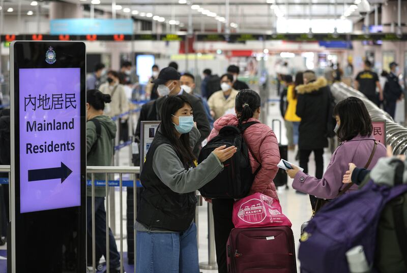 A Hong Kong immigration officer directs travellers to desks to cross the border to China at Lok Ma Chau MTR station, in Hong Kong. Photograph: EPA
