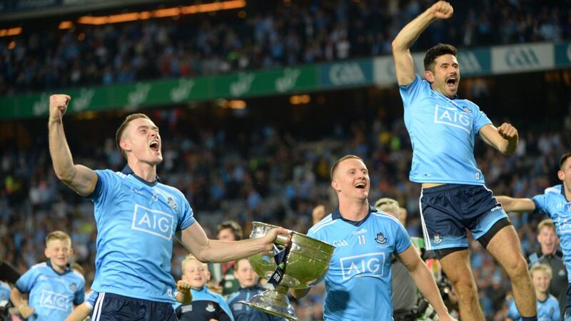 Brian Fenton, Ciarán Kilkenny and Cian O Sullivan celebrate the victory over Kerry with the Sam Maguire trophy. Photograph:  Dara Mac Dónaill
