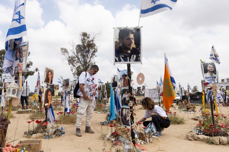 Sigal Manzuri visits the marker of her daughters Norelle and Roya who were killed during the October 7th attacks at the Nova music festival. Photograph: Amir Levy/Getty Images
