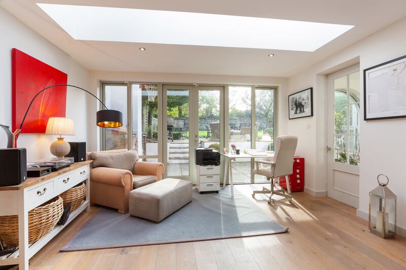 A large office has its own rooflight and doors opening out to the back patio.