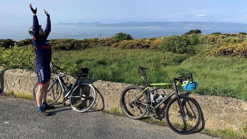 John Lacy stretching and taking in the views at Howth Summit on his morning cycle with Stephen McGovern. Photograph: Stephen McGovern