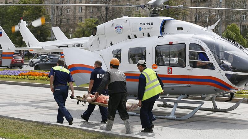Rescuers carry an injured passanger to an ambulance helicopter from the ‘Park Pobedy’ metro station. Photograph: Yuri Kochetkov
