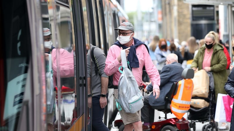 People wearing face masks while waiting at the Jervis Street Luas stop in Dublin. Photograph: Sasko Lazarov/RollingNews.ie