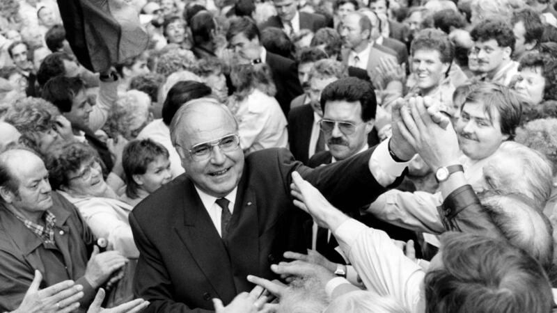 German chancellor Helmut Kohl cheered by the crowd of thousands of East Germans who gathered at the Peace Square for the first election rally after German reunification.  Photograph: Mark-Olivier Multhaup/AFP/Getty Images