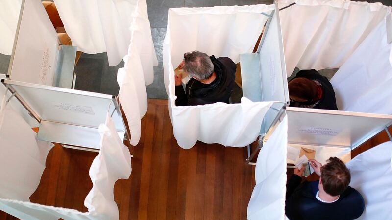 Voters pick their candidates inside voting booths at a polling station in Paris on Sunday. Photograph: Benjamin Cremel/AFP/Getty Images