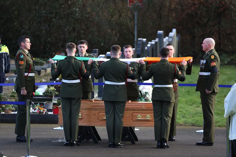 Pall bearers fold the Tricolour at the State funeral of former taoiseach John Bruton at Rooske Cemetery, Dunboyne, Co Meath. Photograph: Dara Mac Dónaill/The Irish Times