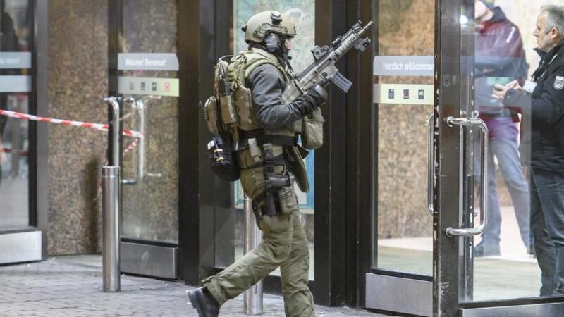 Police and emergency workers stand outside the main railway station  in Dusseldorf, Germany, after an axe attack. Photograph: Alexander Scheuber/Getty Images