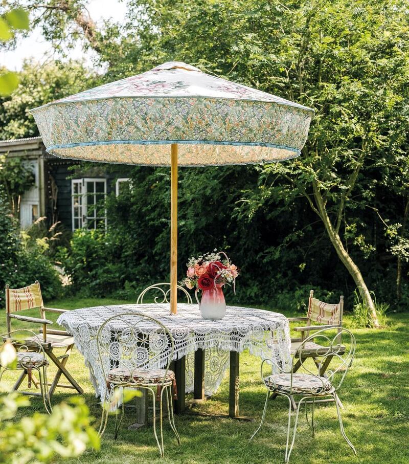 Pearl Lowe’s garden featuring a parasol by Sunbeam Jackie and a lace scarf strewn over the table. Photograph: Dave Watts