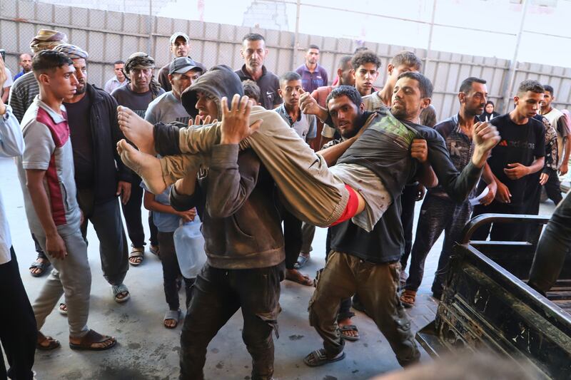 An injured Palestinian man is carried into Nasser Hospital. Photograph: Mariam Dagga/AP
