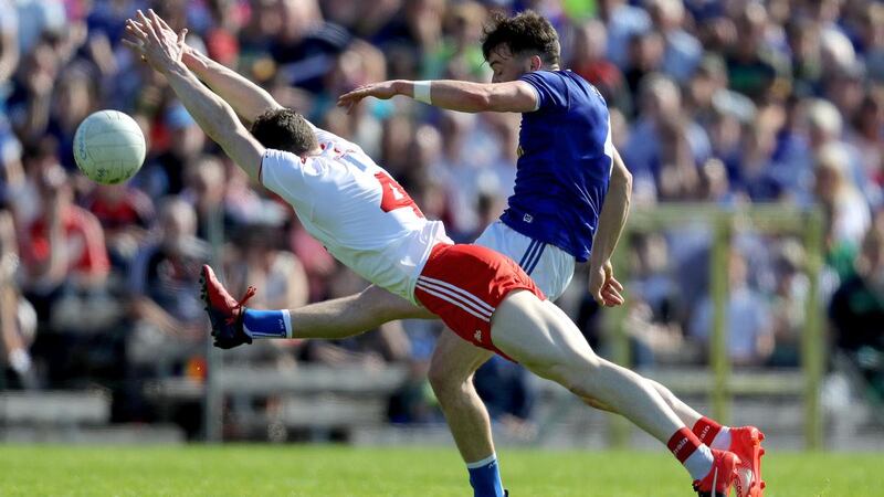 Tyrone’s Rory Brennan tries to block Cavan’s Conor Moynagh during his side’s heavy win in Clones. Photograph: Bryan Keane/Inpho
