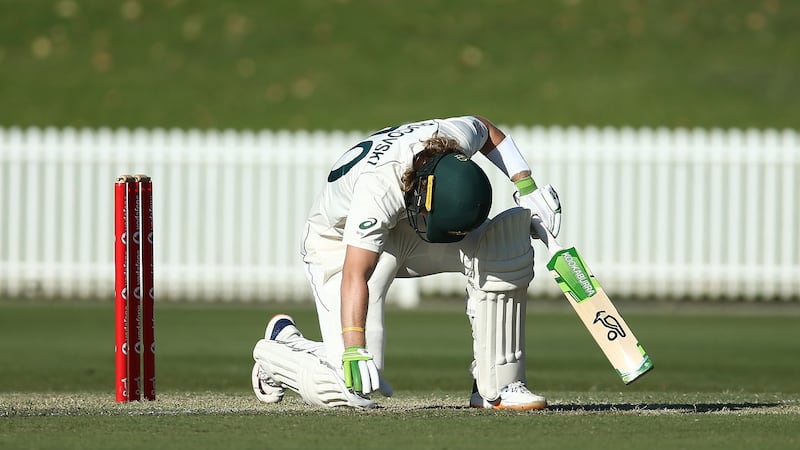 Australia A batsman Will Pucovski kneels on the ground after after he was  struck on the helmet off the bowling of India A’s Kartik Tyagi  at Drummoyne Oval in Sydney. Photograph: Jason McCawley/Getty Images