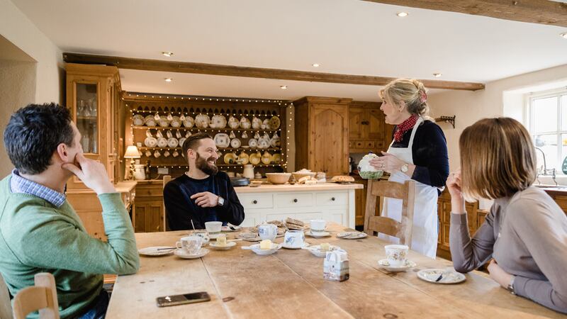 John Mathers, Keelan Higgs, Tracey Jeffery and Louise Mathers settle down to tea and homemade bread inside Tracey's 17th century thatched cottage. Photograph: Declan Devlin
