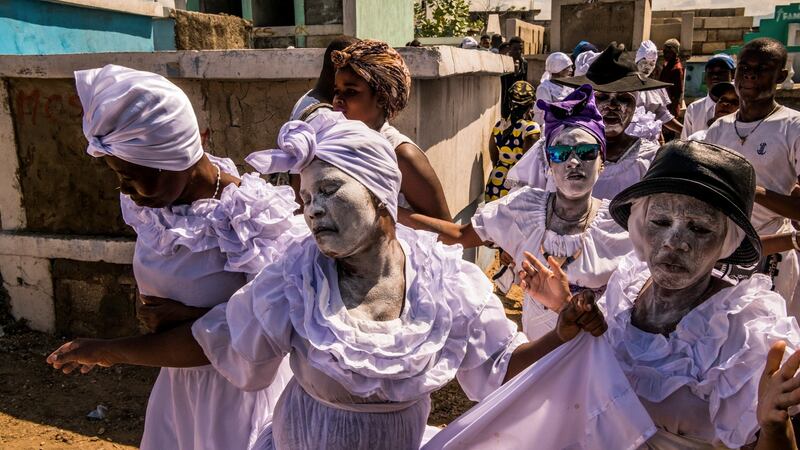A ceremony honoring the Haitian Vodou spirits Baron Samedi and Gede on the Day of the Dead in Port-au-Prince. Photograph: Daniel Berehulak/The New York Times