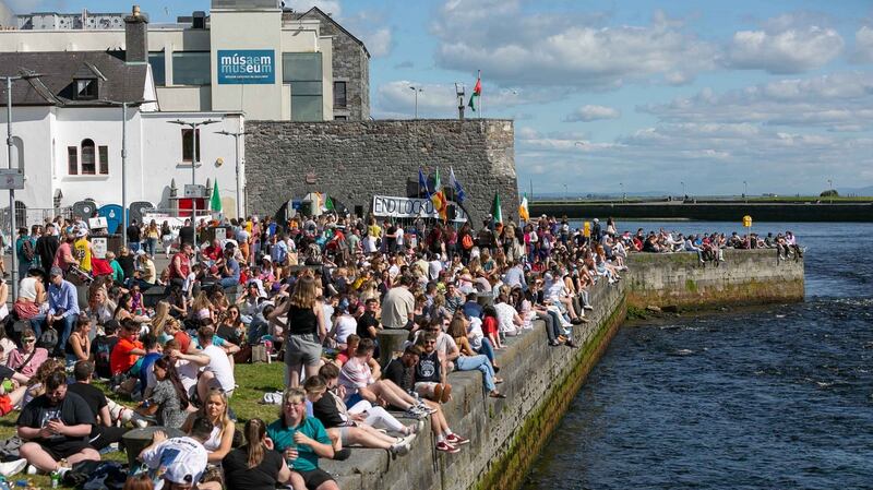 People enjoying the fine weather at the Spanish Arch in Galway on Saturday. Photograph: Andy Newman