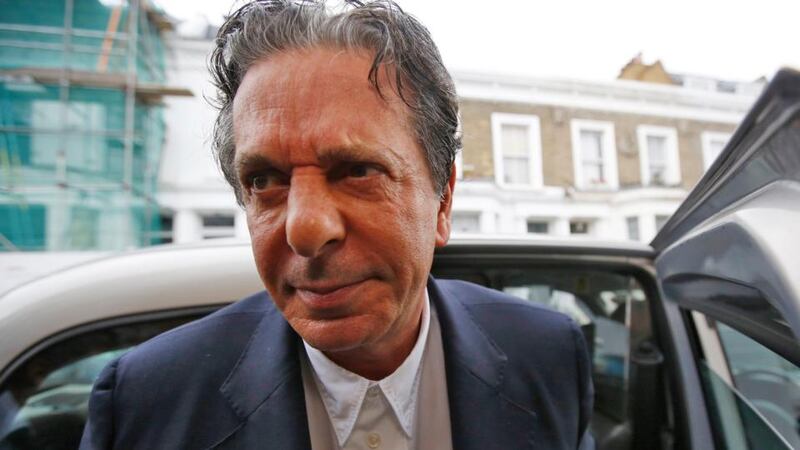 Art collector Charles Saatchi arrives at his home in west London yesterday. Saatchi has been cautioned by police for assaulting his wife, Nigella Lawson. Photograph: Olivia Harris/Reuters