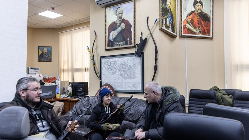 Civilian volunteers check their guns at a territorial defence unit registration office on Saturday in Kyiv. Photograph:  Chris McGrath/Getty Images