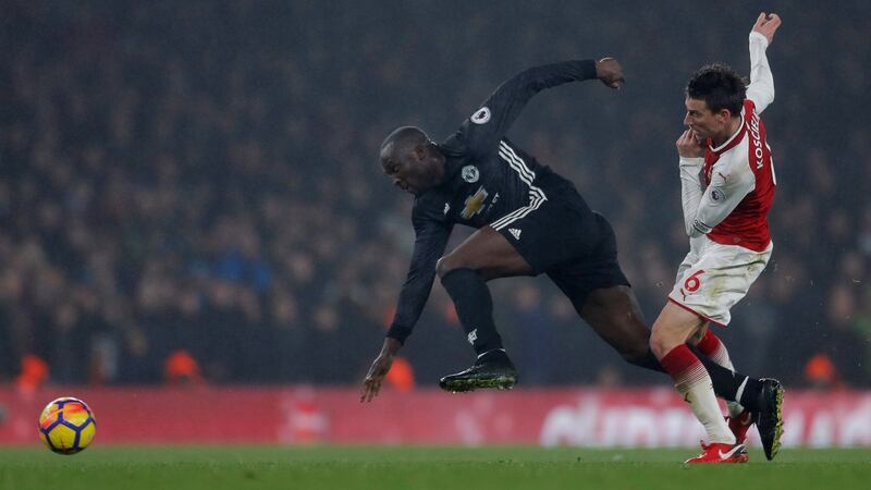 Arsenal’s Laurent Koscielny fouls Manchester United’s Romelu Lukaku. Photograph: Andrew Couldridge/Reuters