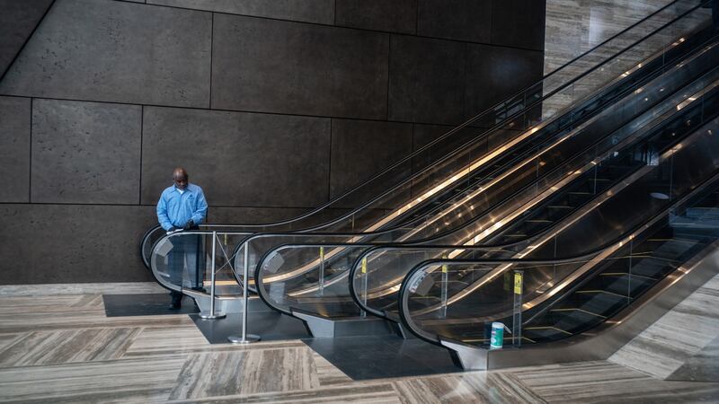 A worker cleans escalator railings at Hudson Yards in New York. Photograph: Todd Heisler/The New York Times