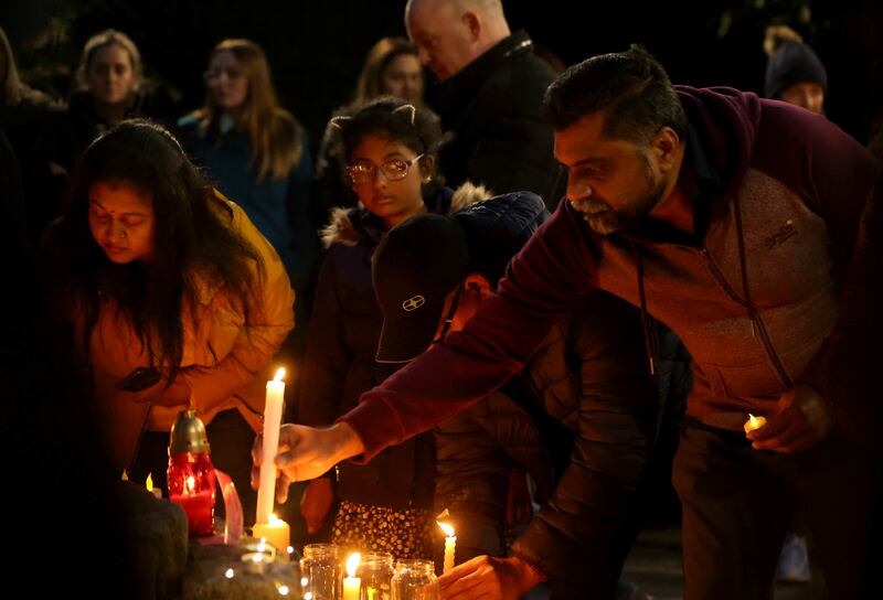 People light candles as they attend a vigil at Market Square, Letterkenny, on Monday. Photograph: PA