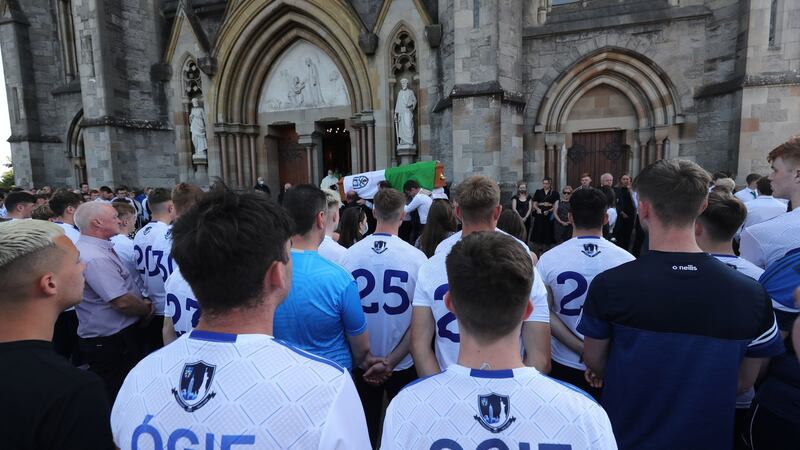Mourners wearing Monaghan GAA jerseys with Ógie written on back at funeral. Photograph: Niall Carson/PA Wire