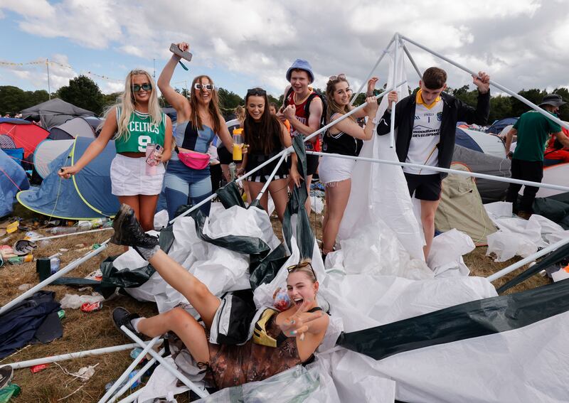 Festivalgoers on day three with their collapsed tent at the Jimmy Hendrix campsite following a night of heavy rain. Photograph: Alan Betson

