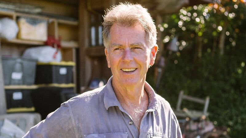 John Dunbar, a participant in the first Ironman Triathlons, outside one of the buildings at his vacation rental property in Haiku, Hawaii. Photograph: Michelle Mishina-Kunz/New York Times
