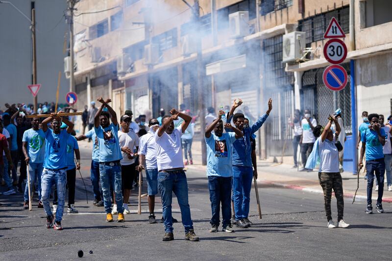 Anti-government protesters carrying weapons in Tel Aviv unrest. Photograph: Ohad Zwigenberg/AP