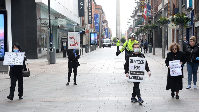 Debenhams workers gathered to protest outside the store on Henry Street, Dublin who were asked to move on by the Garda. Photograph: Dara Mac Dónaill / The Irish Times