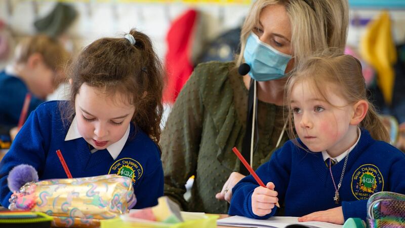 Teacher Darrine Taaffe helping out young students on their first day back at school in senior infants class at Scoil Cliodhna Community National School in Carrigtwohill, Co Cork. Photograph: Michael Mac Sweeney/Provision