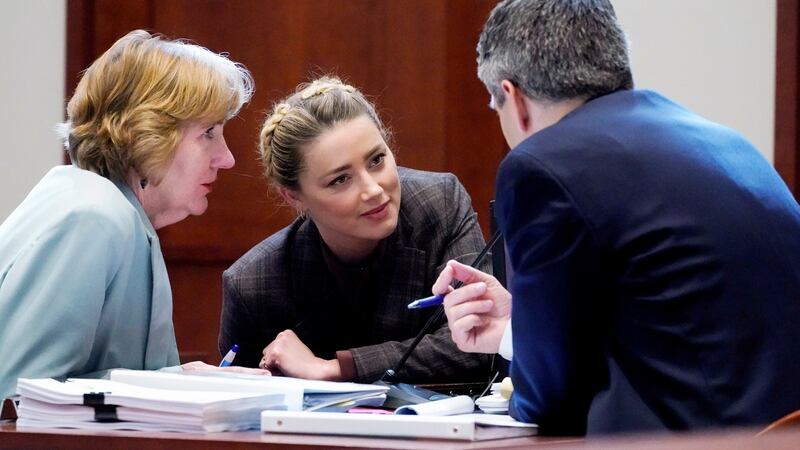 Actress Amber Heard talks to her attorneys in the courtroom on Monday. Photograph: Steve Helber/Pool/EPA