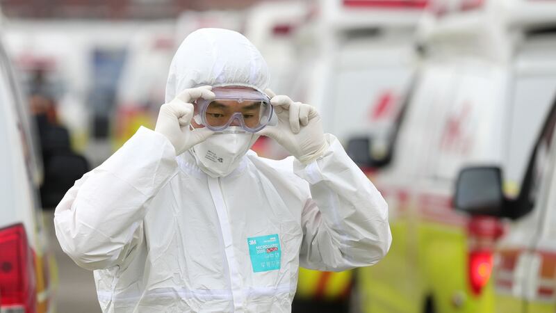 A South Korean paramedic wearing protective in Daegu on Sunday. Photograph: /Yonhap/AFP/Getty