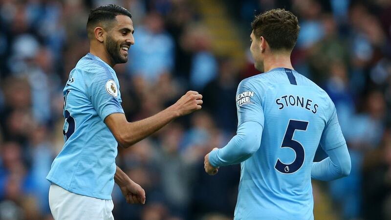 Riyad Mahrez of Manchester City celebrates with John Stones after scoring his team’s fourth goal  against Burnley. Photograph: Alex Livesey/Getty Images