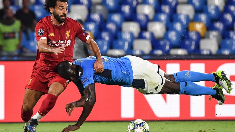 Napoli defender Kalidou Koulibaly tries to tackle Mohamed Salah. Photograph: Andreas Solaro/AFP/Getty