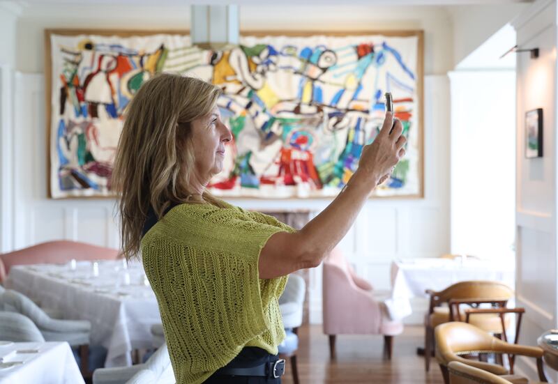 Alison Iles visiting from Canada admires some of the art on show in the  Landline Terrace of the Park Hotel in Kenmare Co. Kerry  Photograph: Bryan O’Brien