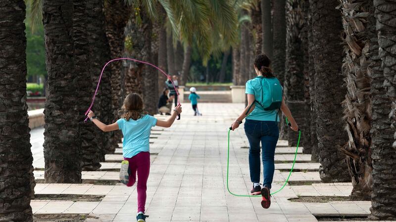 A woman jumps rope with a girl in Valencia , Photograph: Jose Jordan/AFP via Getty Images