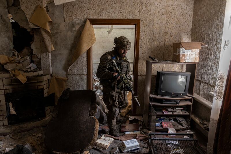 A fighter with the volunteer Carpathian Sich, who uses the code name Boris, searches a house used by Russian soldiers in the village of Stavky, Ukraine, on October 5th. Photograph: Ivor Prickett/New York Times