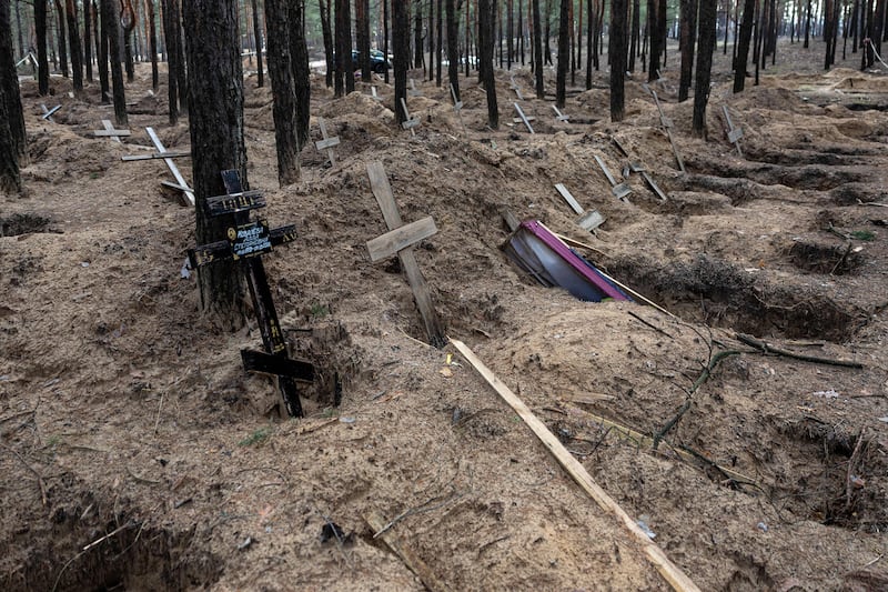 Empty graves after the exhumation of bodies in the mass graves dug during the Russian occupation in the city of Izium. Photograph: Sameer Al-Doumy/Getty Images/AFP