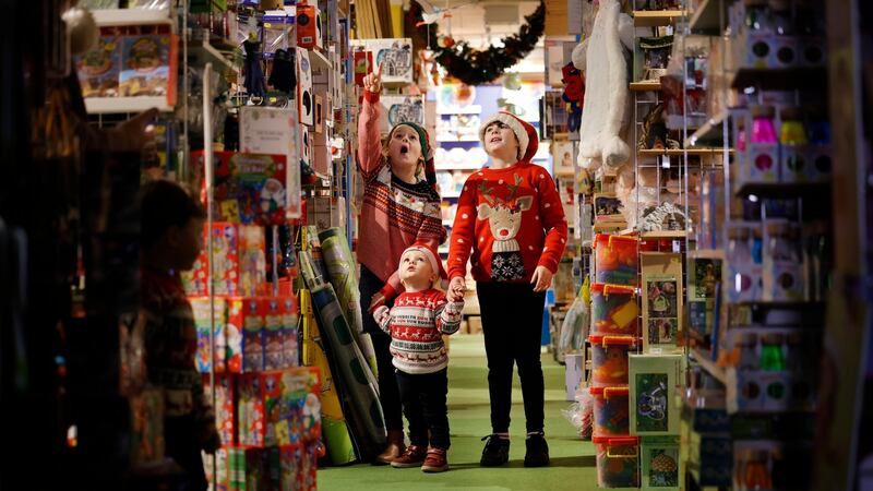 Olivia Porter (10), Ben Davidson (2) and Roisin Duffy (12) enjoying their grandfather’s toy shop. Photograph: Alan Betson