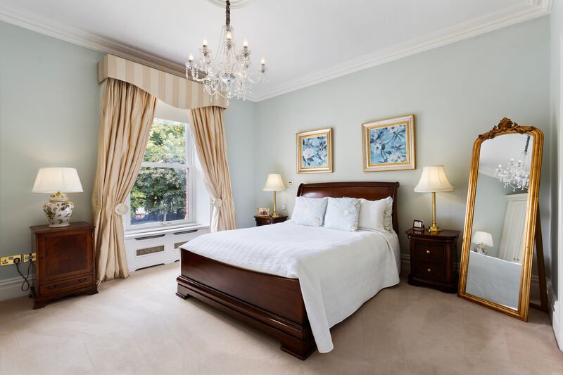A double bedroom upstairs features a wall of wardrobes
