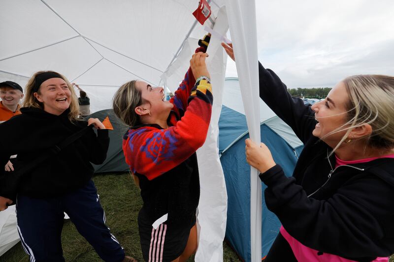 Electric Picnic 2025: Sarah Flaherty from Dublin, and Sarah Byrne and Caoimhe Byrne from Carlow, set up a gazebo. Photograph: Alan Betson