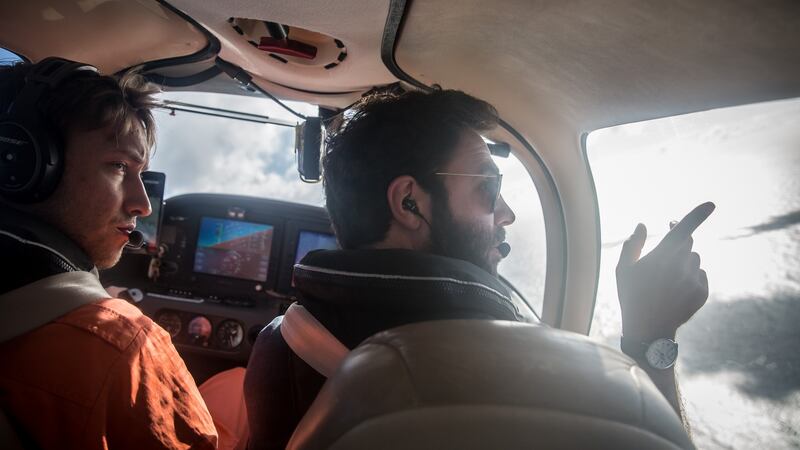 Volunteer pilot Manos Radisoglou advises a trainee pilot while looking out the window of the Moonbird. Photograph: Sally Hayden